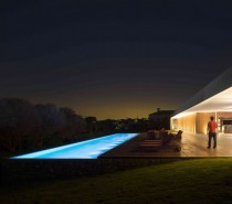 Marcio Kogan's Casa Lee Concrete House- pool at night with wooden decking