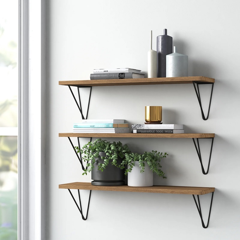 Three wooden shelves with geometric brackets