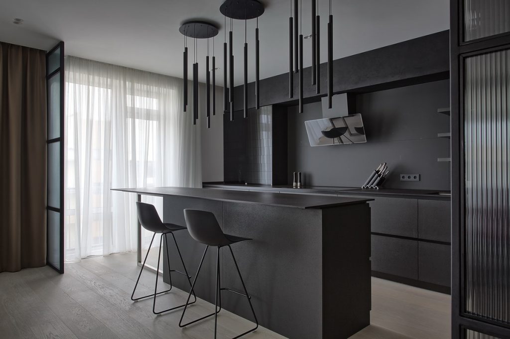 black kitchen with rod lighting