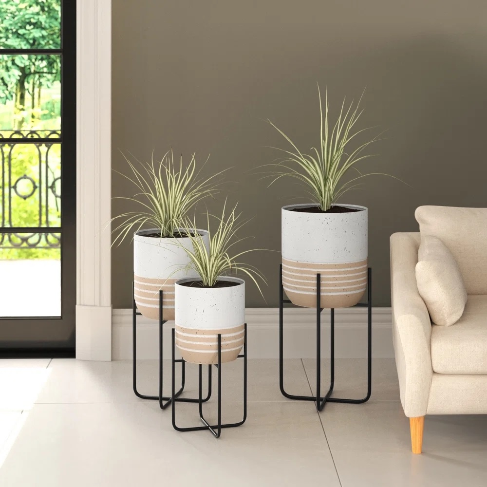 White and beige planters with black metal bases