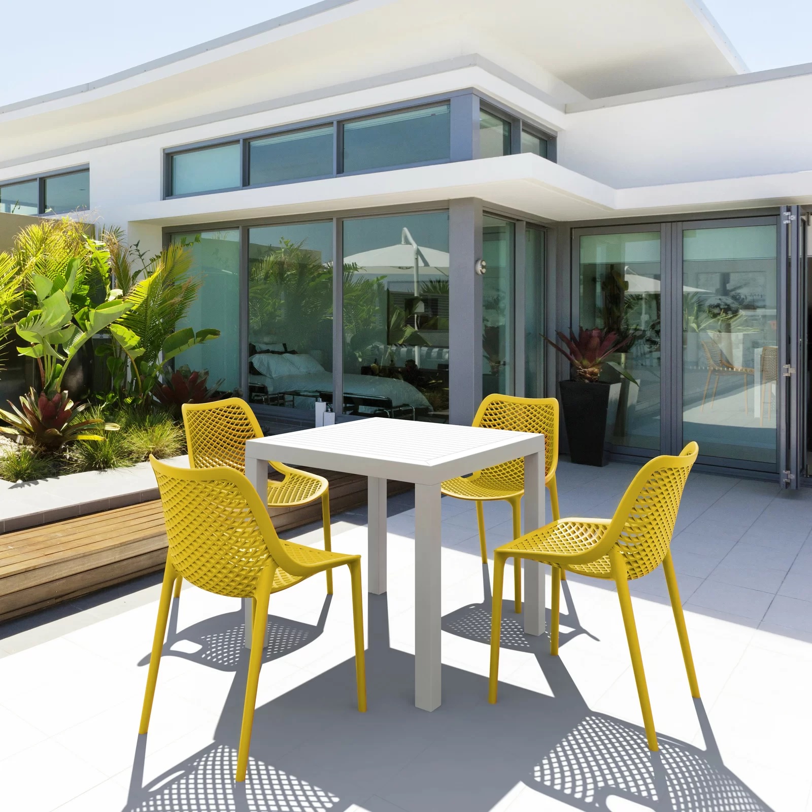 bright yellow outdoor dining chairs, a set of four