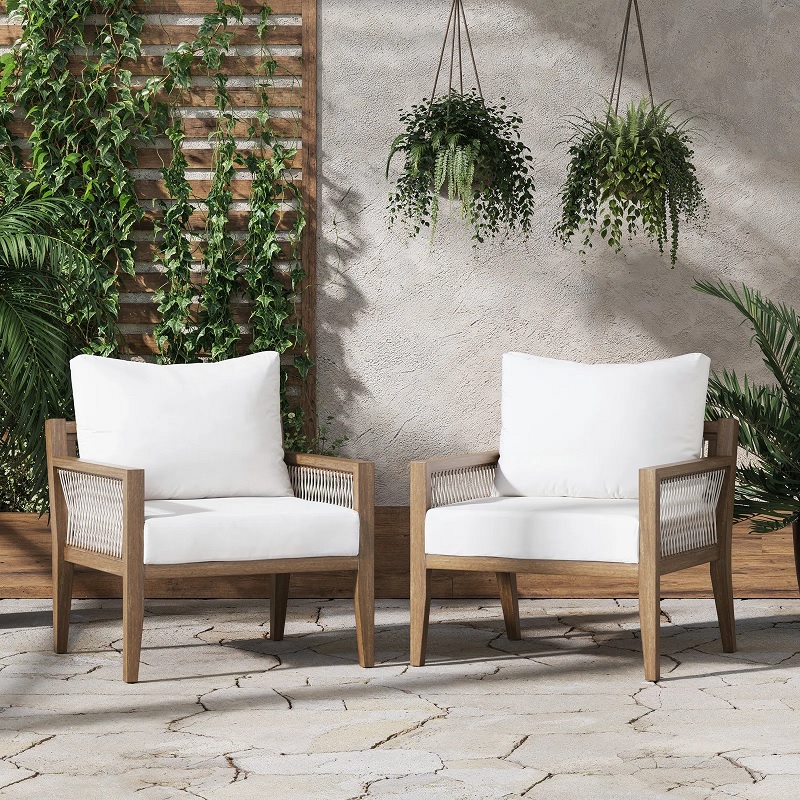 two contemporary outdoor wooden armchairs with white cushions and white woven sides