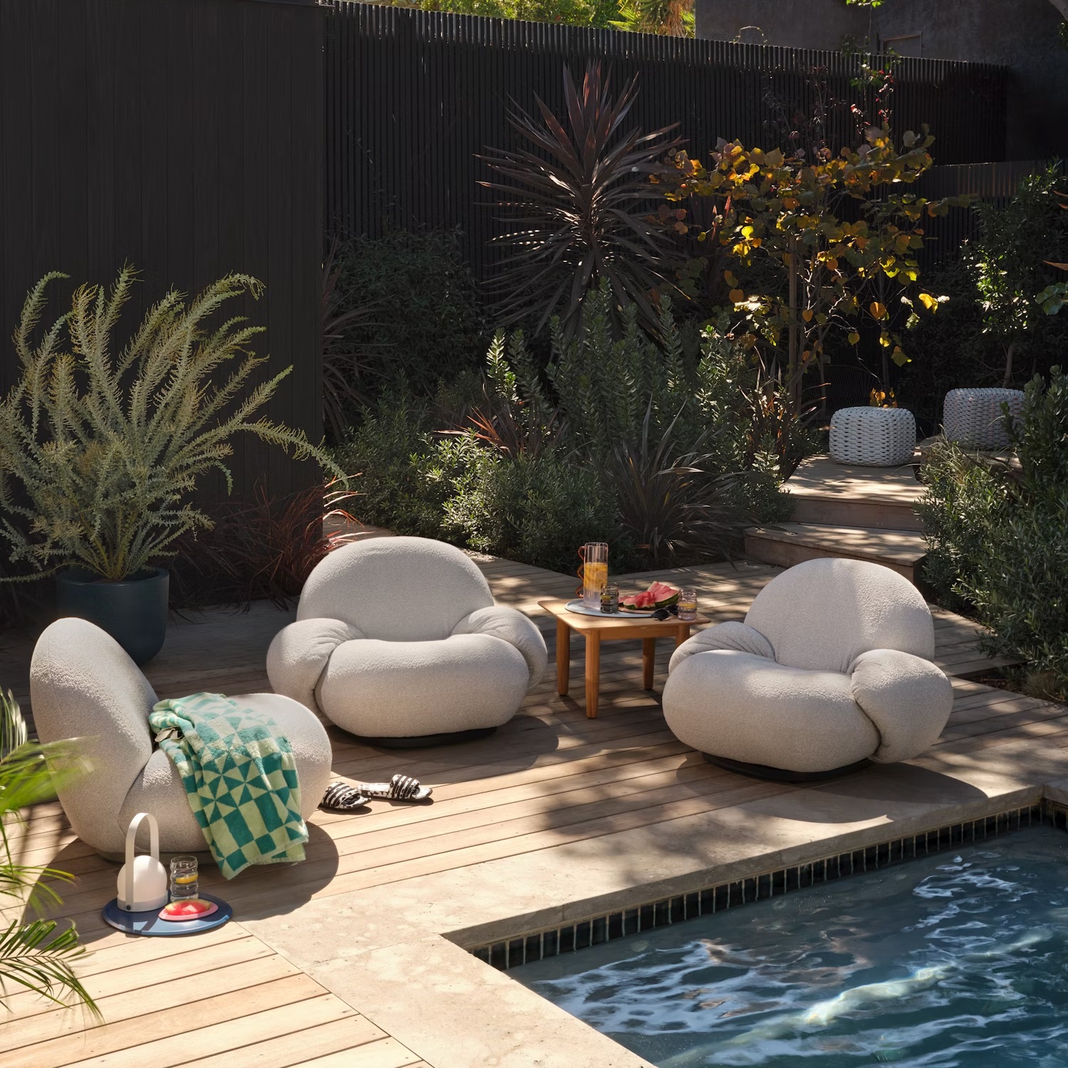 overstuffed upholstered lounge chairs near pool