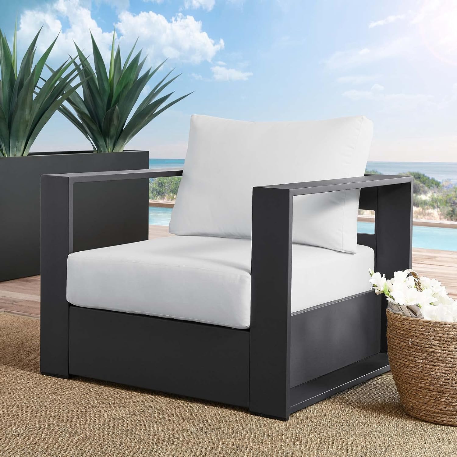 minimalist modern outdoor armchair with black base and white cushions