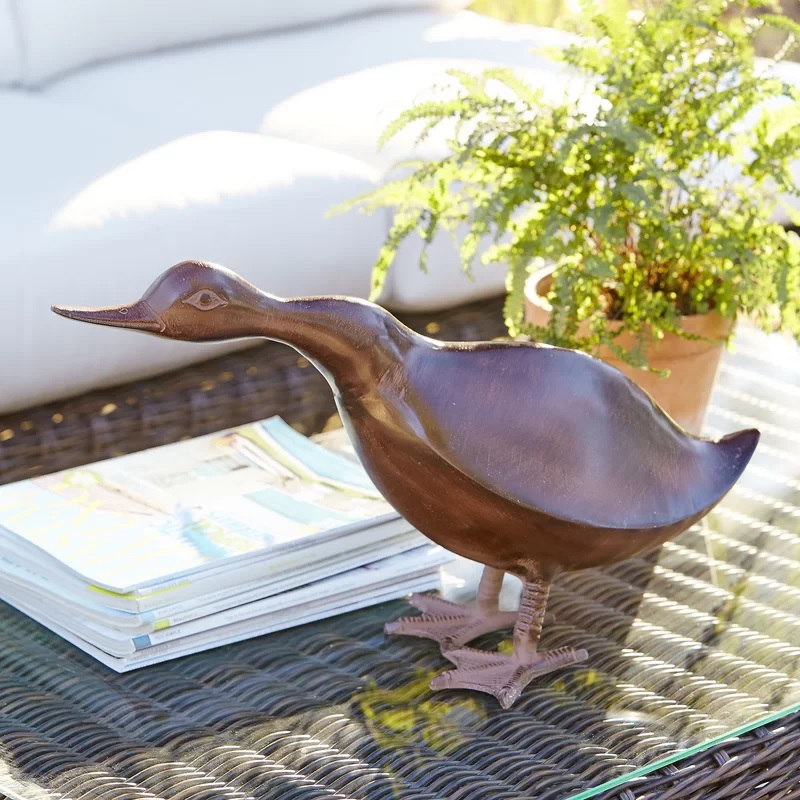 Bronze-colored outdoor duck statue