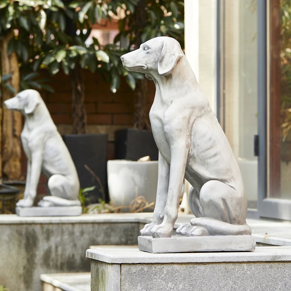 Two dog garden statues guarding an entryway