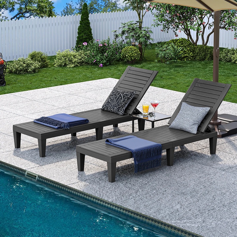 Two poolside chaises made from black polypropylene