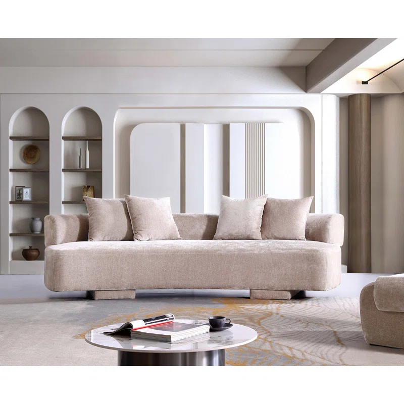 Beige upholstered curved sofa