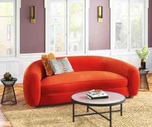 Orange upholstered curved sofa