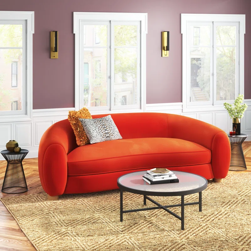 Orange upholstered curved sofa