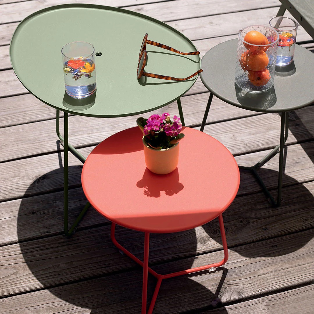 A grouping of colorful outdoor side tables