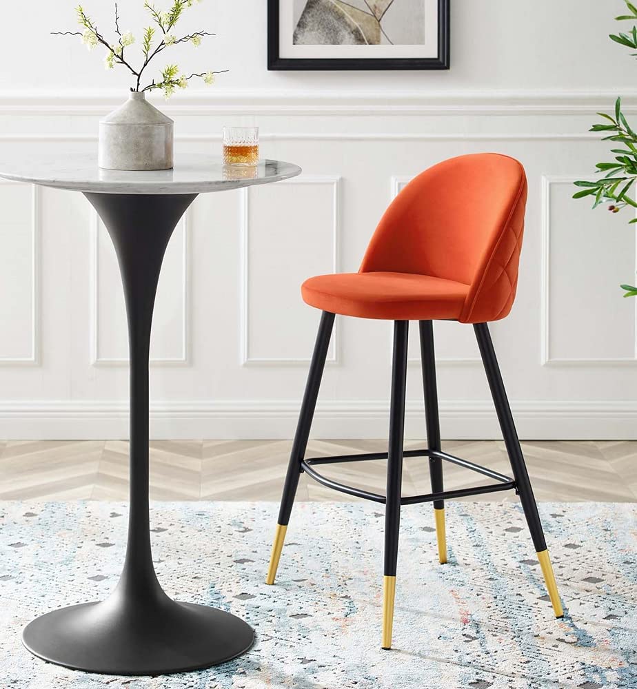 bright orange upholstered bar height stools with black legs and gold capped feet quilted backrest tufted design glam mid century furniture for kitchen seating ideas