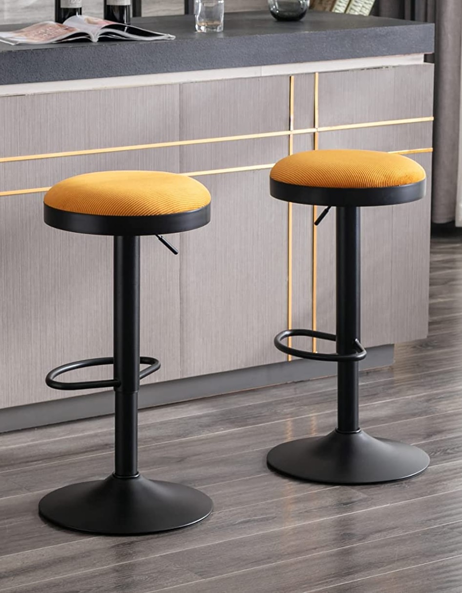 courduroy upholstered swivel bar stools yellow upholstery black pedestal base height adjustable seating for dine in kitchen counter arrangement bar height seating ideas