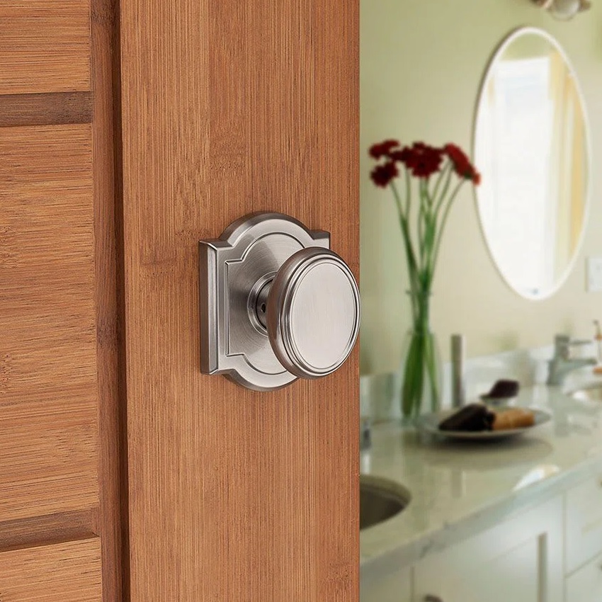 brushed nickel door knob with ornamental arched back plate and round knob simple nickel finish attractive doorknobs for bathrooms privacy knob locking or unlocking styles available