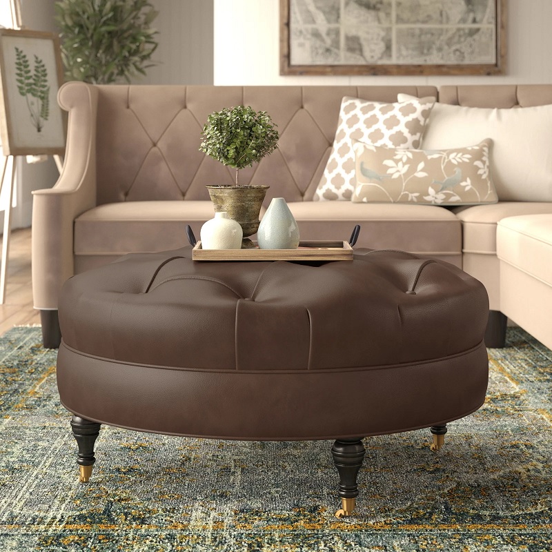 classic brown leather ottoman with button tufting and turned black wooden legs with brass rolling casters movable large ottoman for living room cocktail table ideas traditional