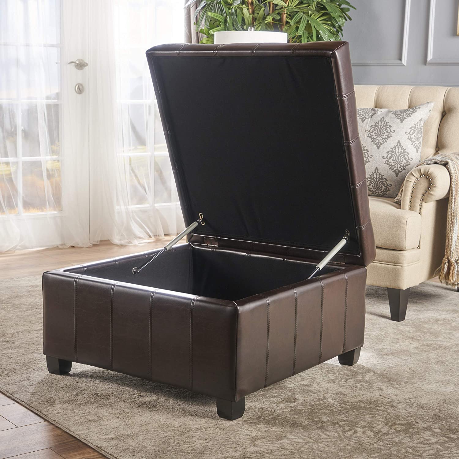 square brown leather storage ottoman with stitched details and lift top lid spacious storage cocktail ottoman for living room multipurpose space saving furniture ideas