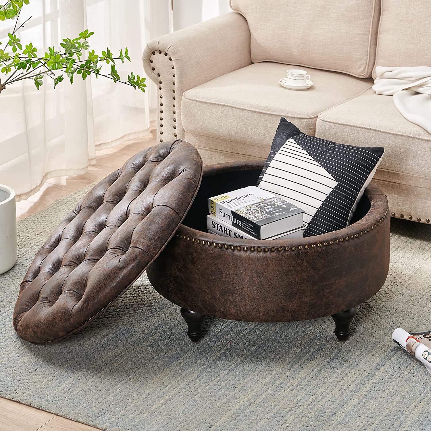 traditional round storage ottoman leather upholstery with distressed finish button tufted removable lid with decorative nailhead trim and turned legs sophisticated storage table