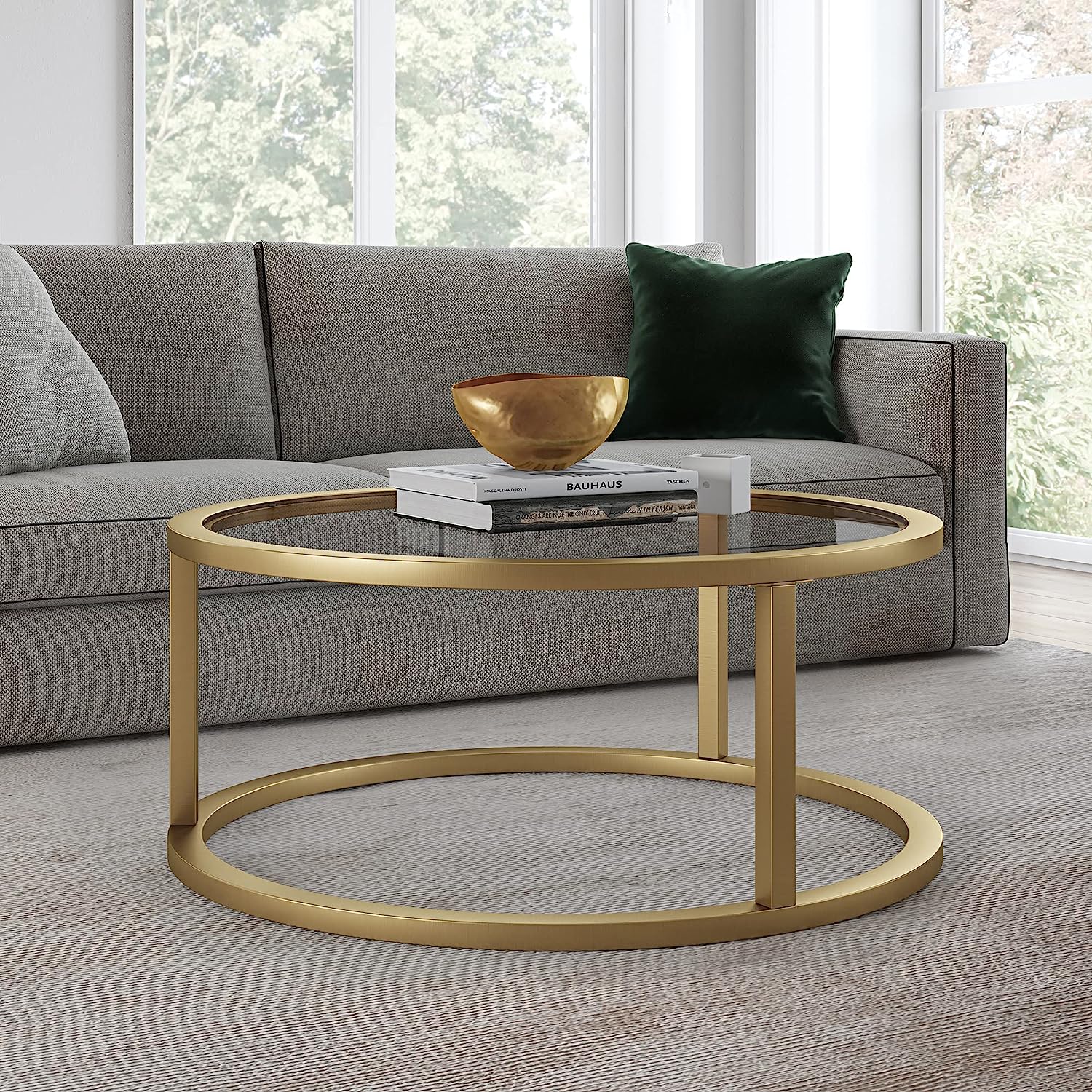 round glass and gold living room table with transparent glas tabletop and brushed golden base contemporary glam furniture cocktail table for living room minimalistic base modern