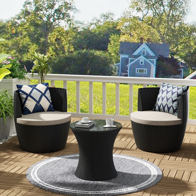 small space black outdoor patio furniture with round barrel chairs with cushions and round small coffee table glass top faux wicker furniture weather resistant seating idea