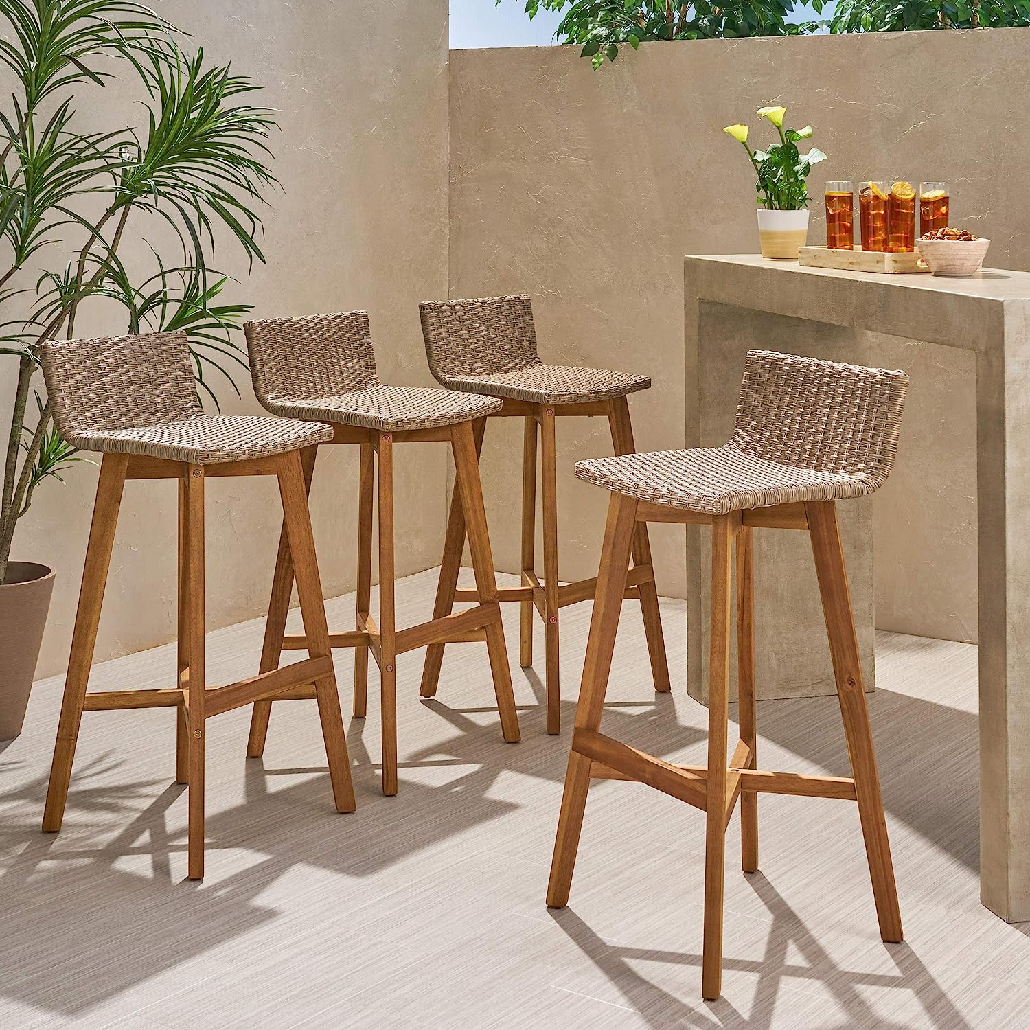 group of four outdoor wicker bar stools with low backrest that can fit beneath a table wooden base faux rattan seating high quality designer furniture for patio affordable