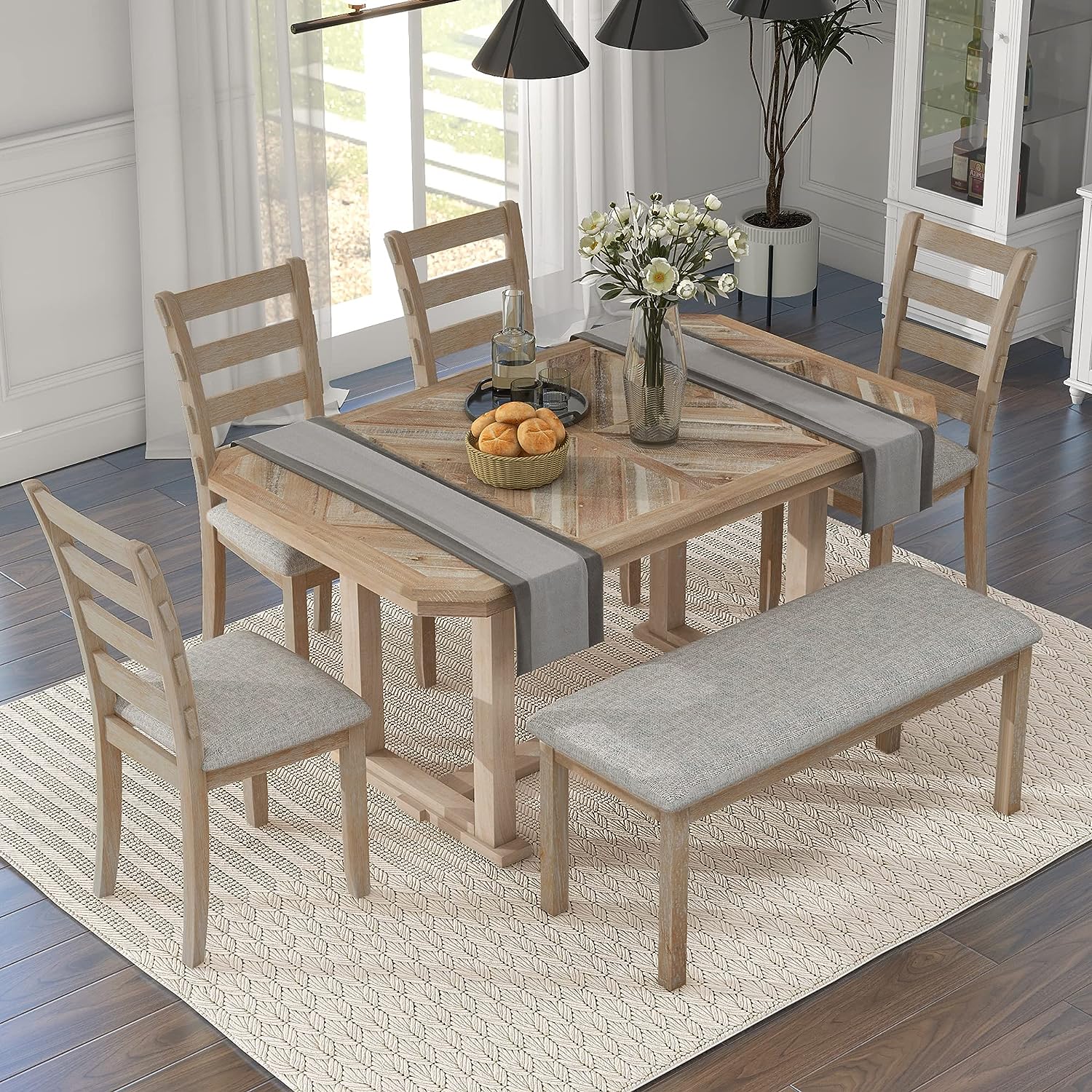 light weathered wood farmhouse dining table with bench and four ladderback chairs traditional dining room furniture for country farmhouse interior decor theme inspiration