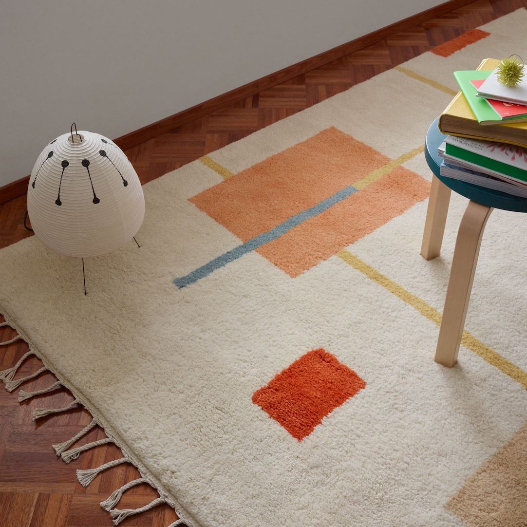 designer mid century modern wool rug by Anna Pirkola and Ina Nordback geometric pattern with orange blue and earth tone braided fringe retro antique style retro rug