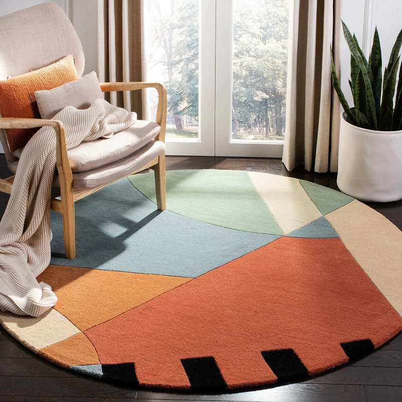 red orange yellow blue mid century modern circle rug made with plush wool pile carved details creative circular area rug for reading nook accent chair arrangement idea