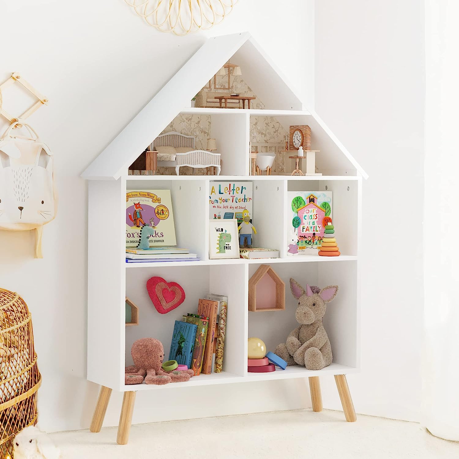 scandinavian house shaped white kids bookshelf with splayed wooden legs multiple cubbies combination bookcase and dollhouse combination multipurpose storage furniture for nursery