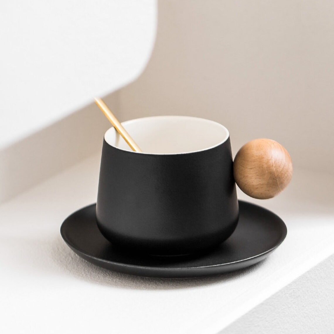 matte black coffee mug with spherical wooden handle and matching saucer stylish designer latte mugs for sale online creative handmade designer kitchen gifts