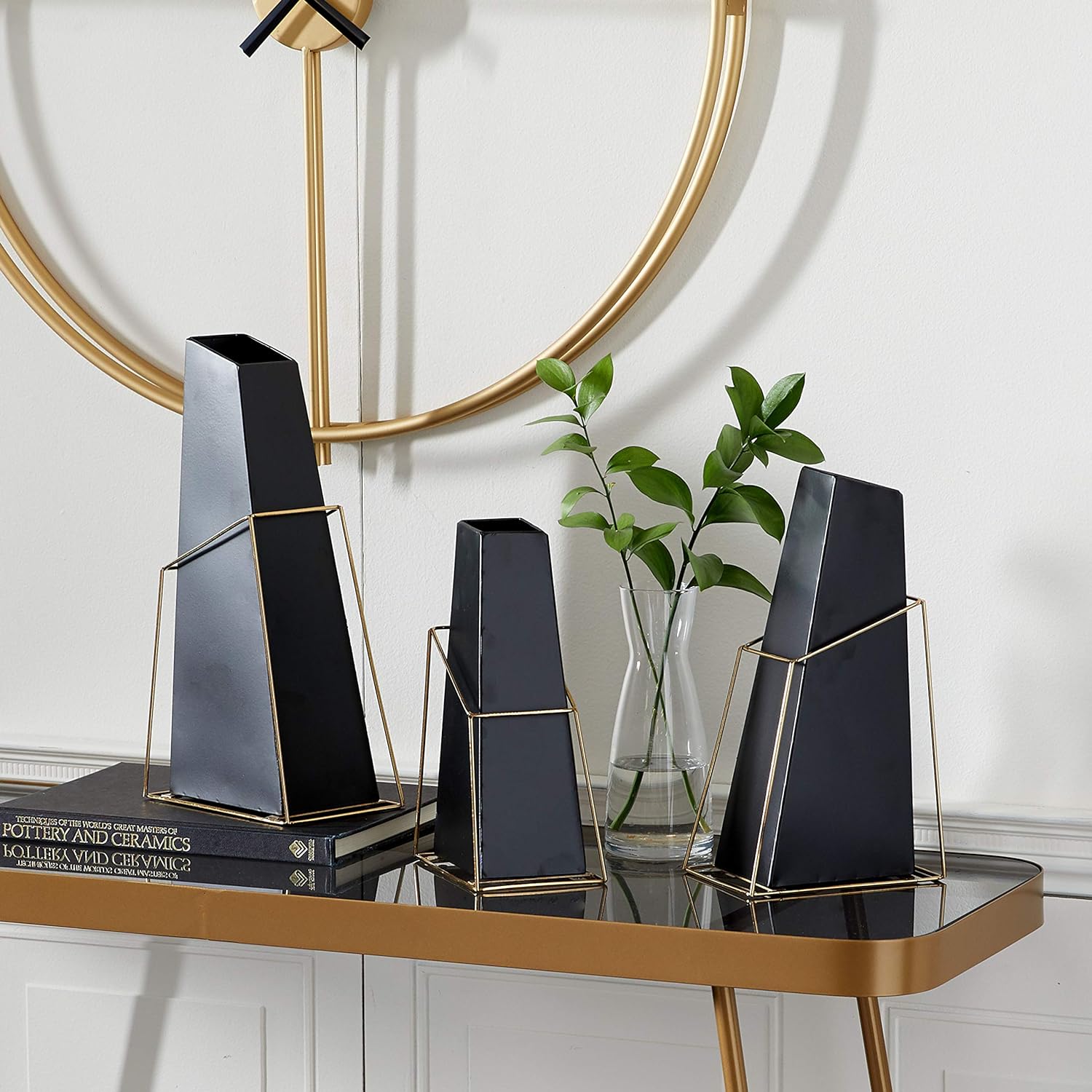 geometric black modern vase made from ceramic trangular angled shape with golden wire metal framing unique contemporary decor for minimalist interior theme