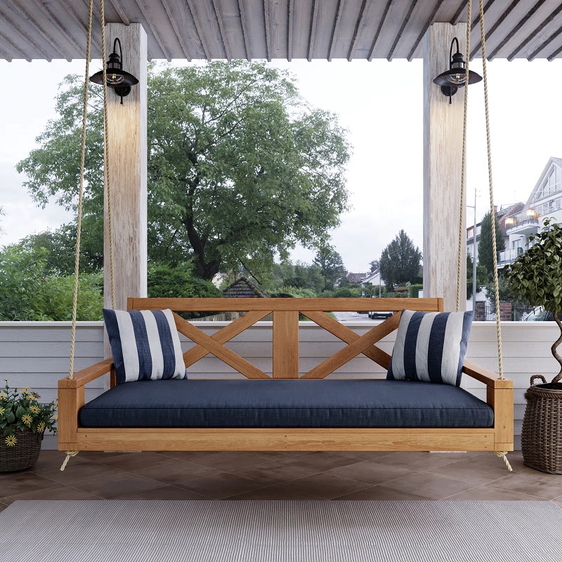 wood porch swing with blue cushions