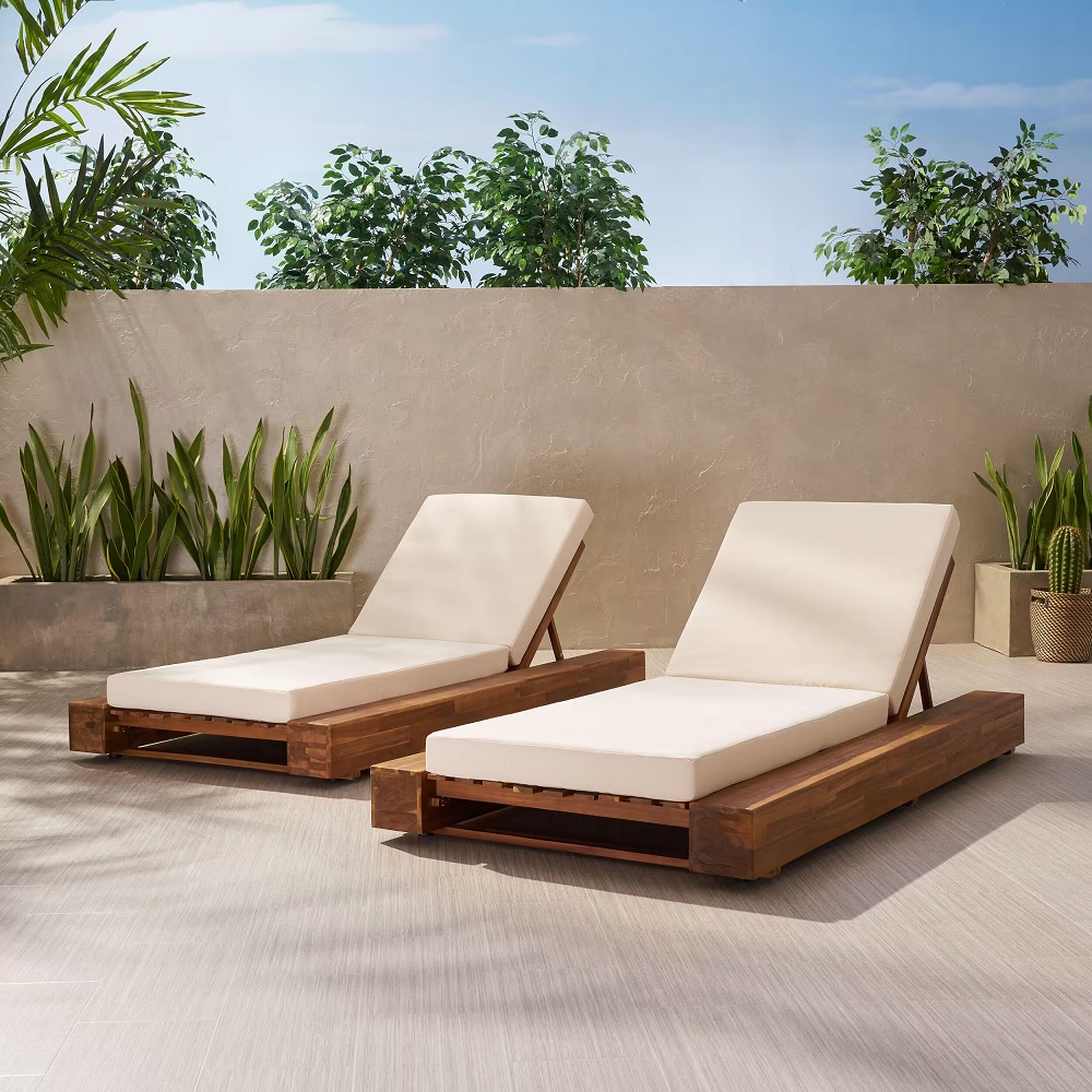 two reclining chaise lounges with white cushions and wood bases