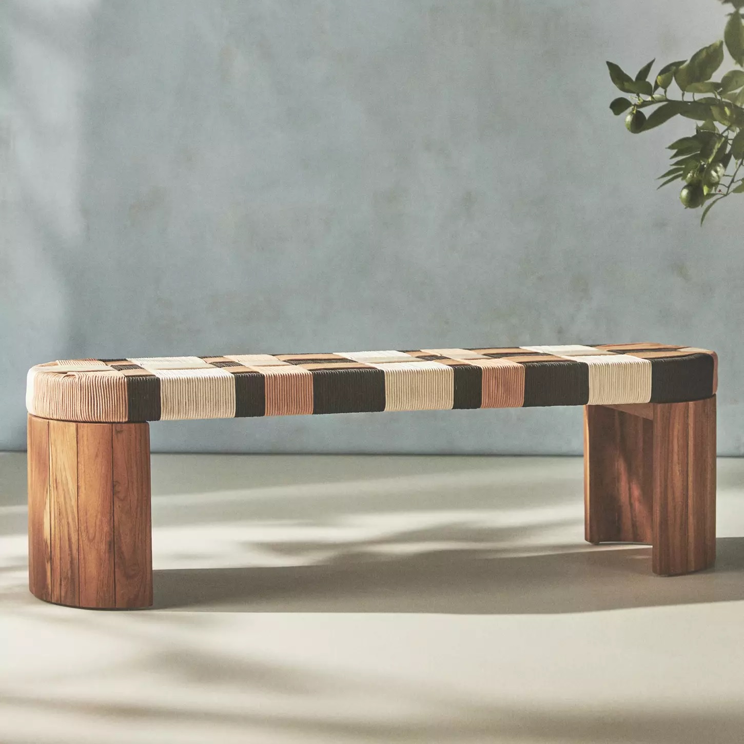 oval-shaped bench with woven checker pattern seat