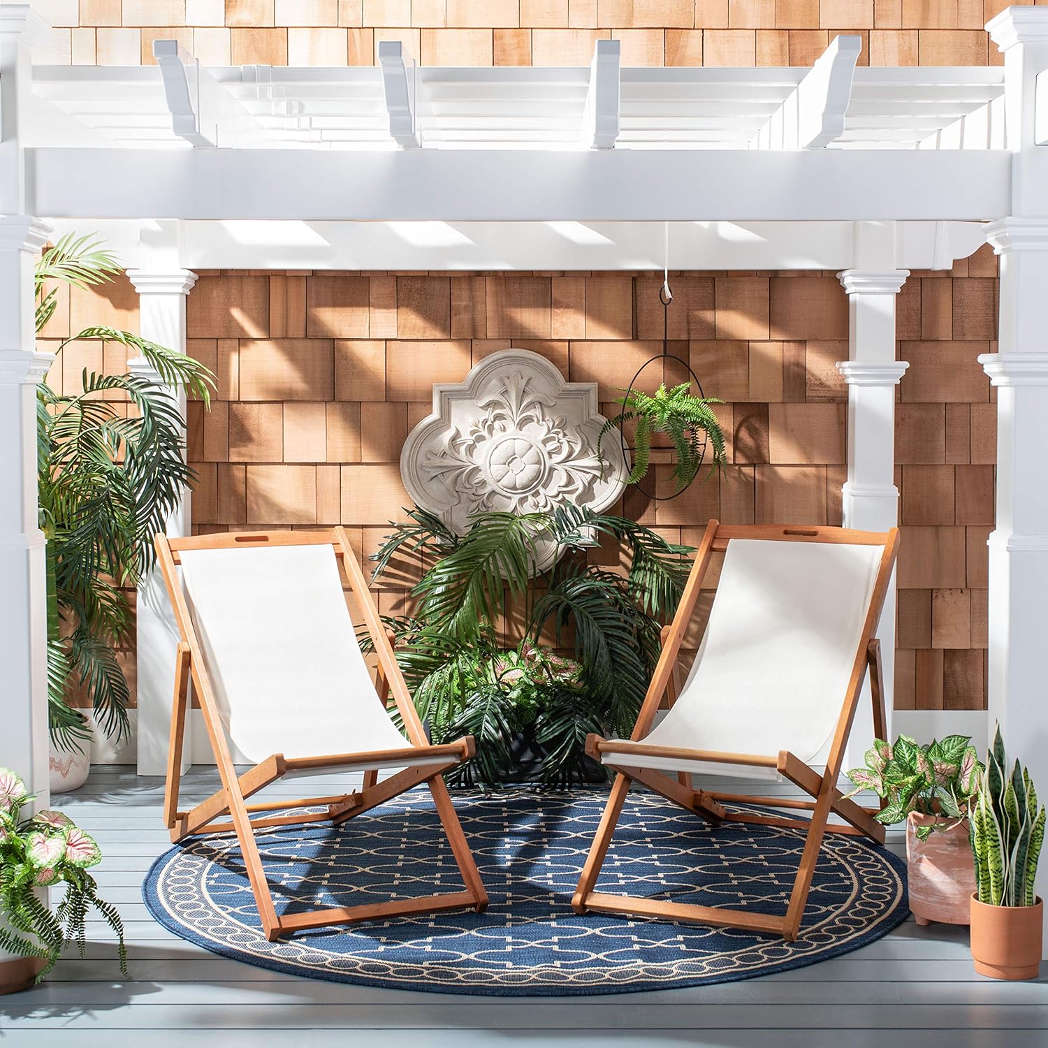 two folding wood sling chairs with white seats