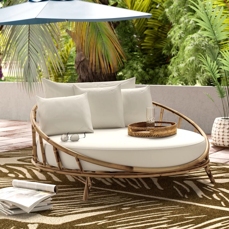 round wooden patio daybed with white cushions