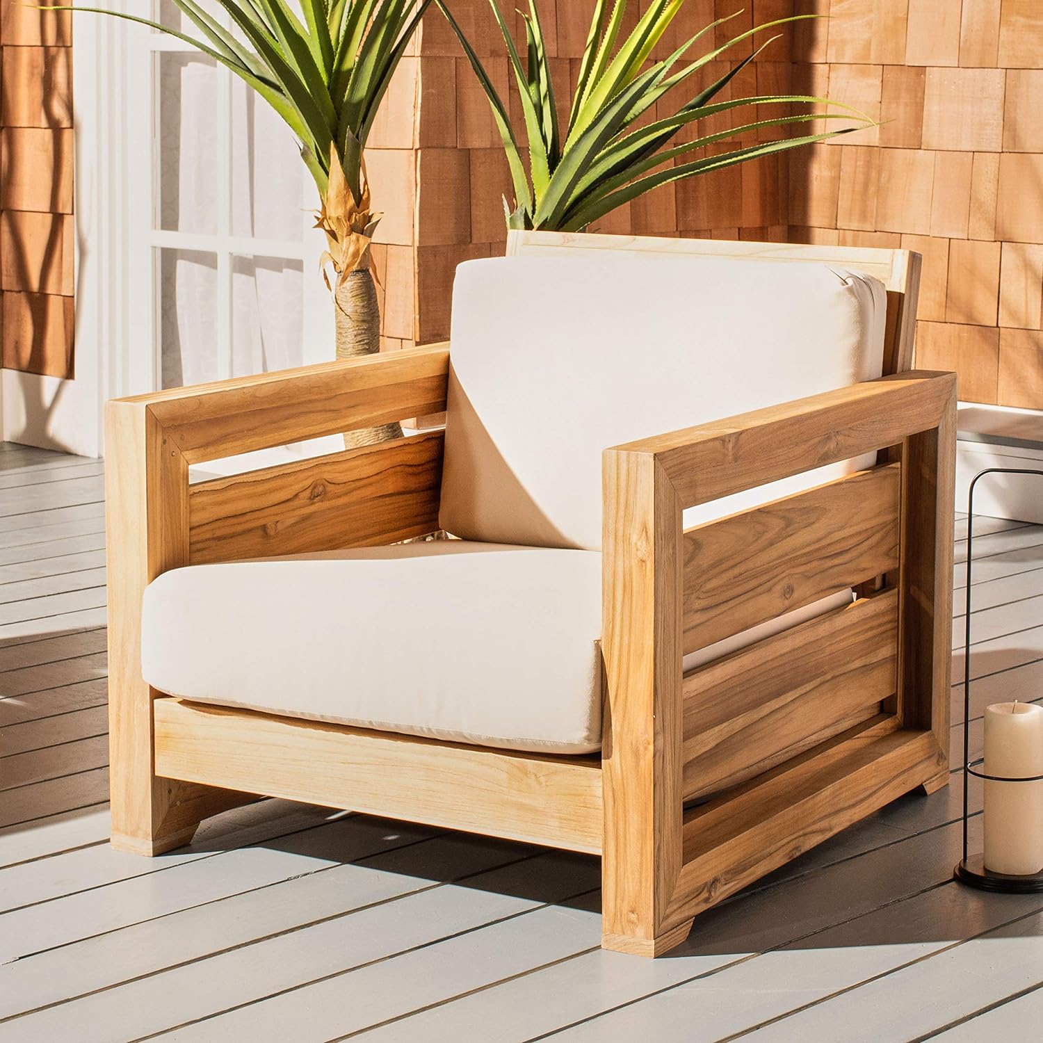 tropical style armchair with slatted wood sides, sitting on patio outdoors