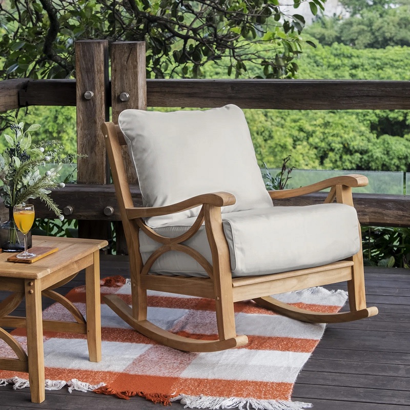 wood rocking chair with beige cushions and decorative sides