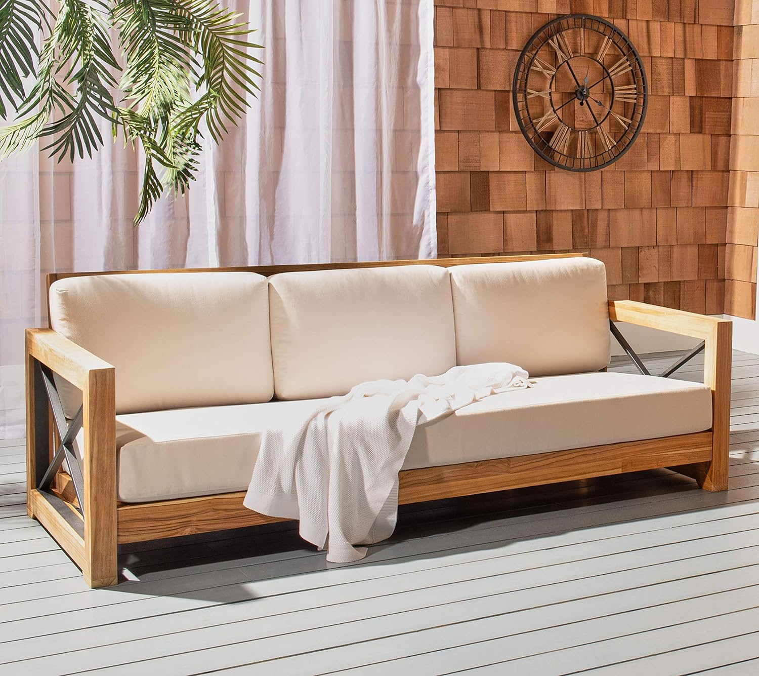 wood sofa on patio with black-colored cross braces on armrests