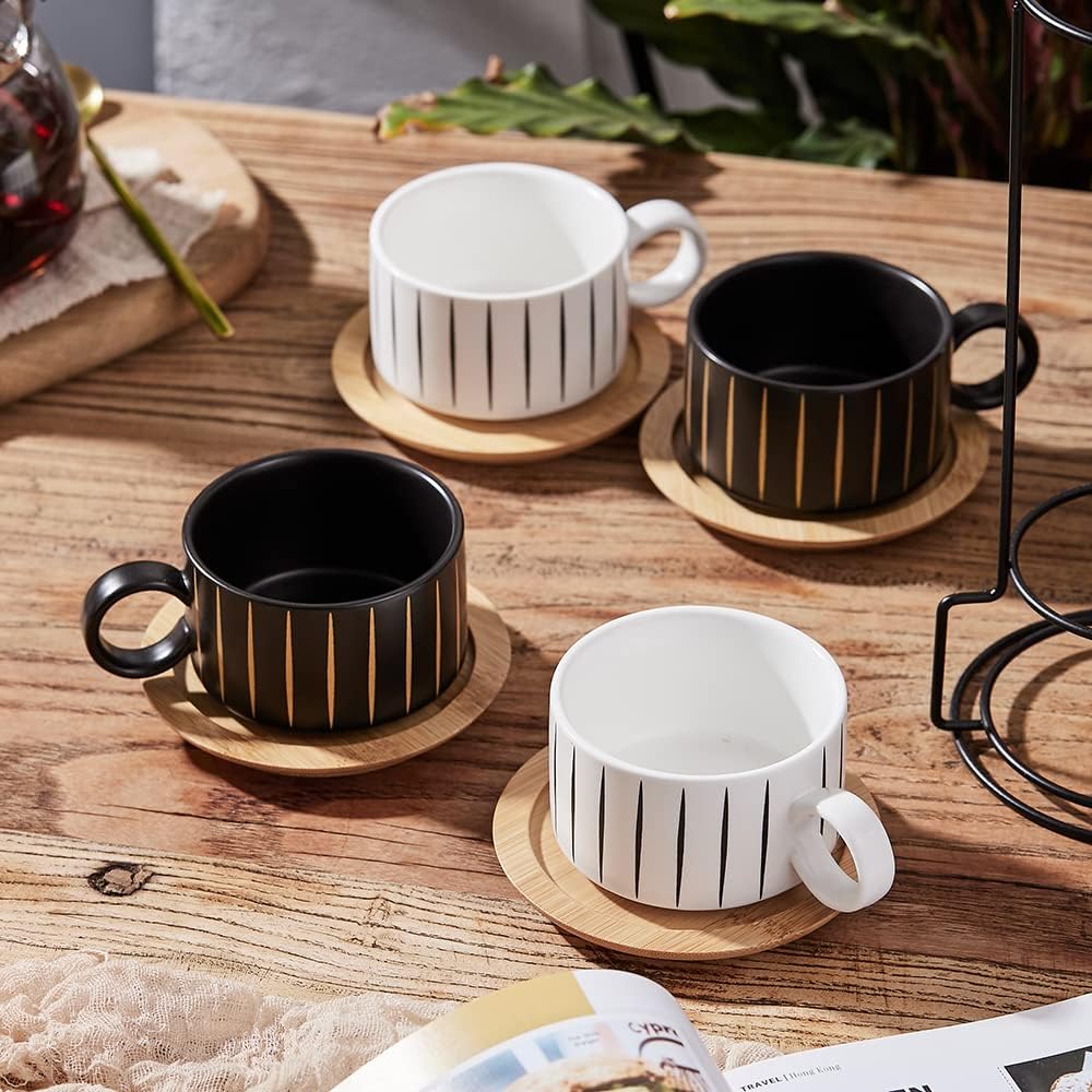 Set of four modern cappuccino cups and wooden saucers