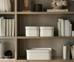 White decorative storage boxes on a shelf