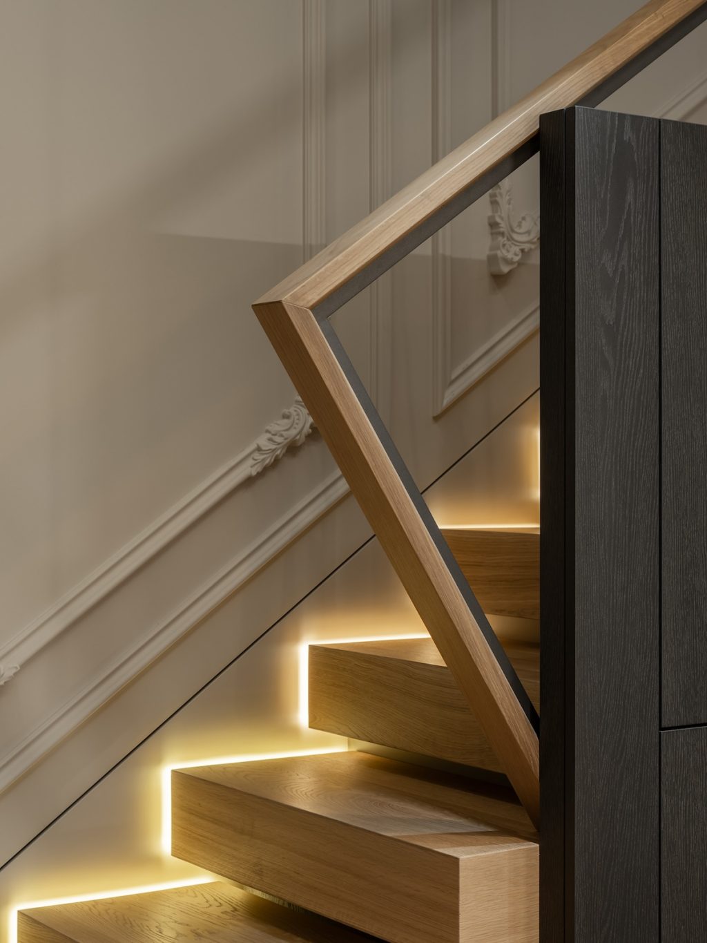 wooden staircase with lights