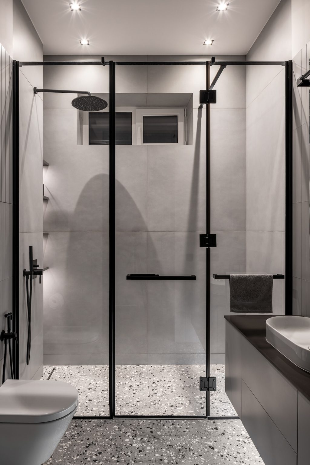 grey bathroom with glass partition