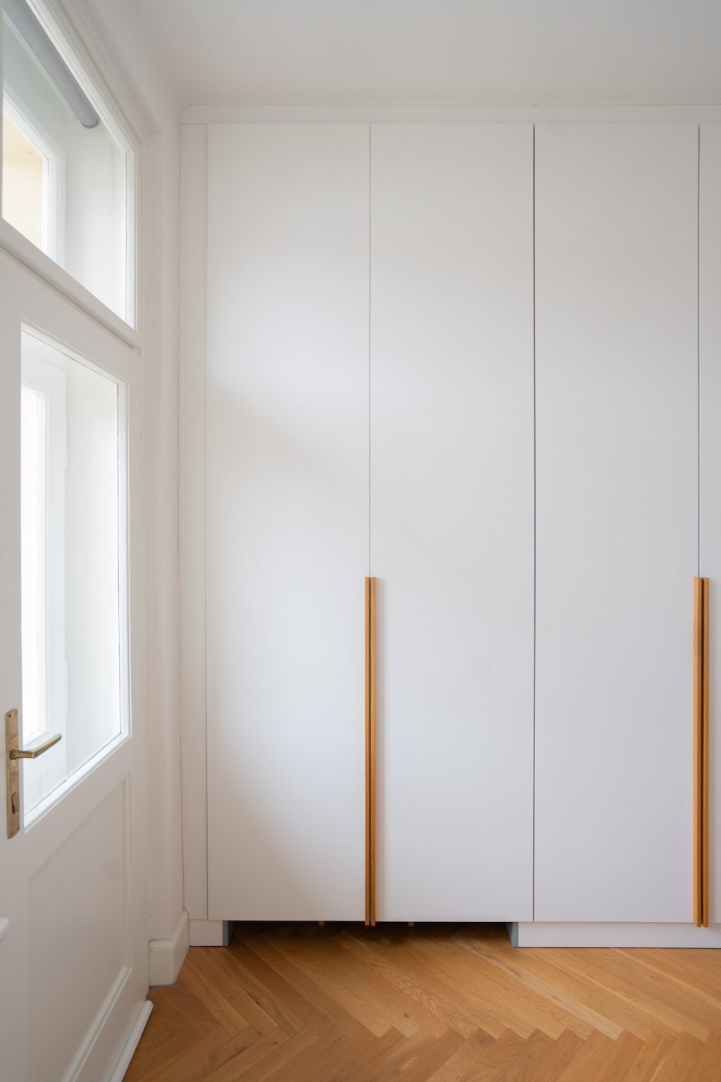 white cabinetry with wooden hardware