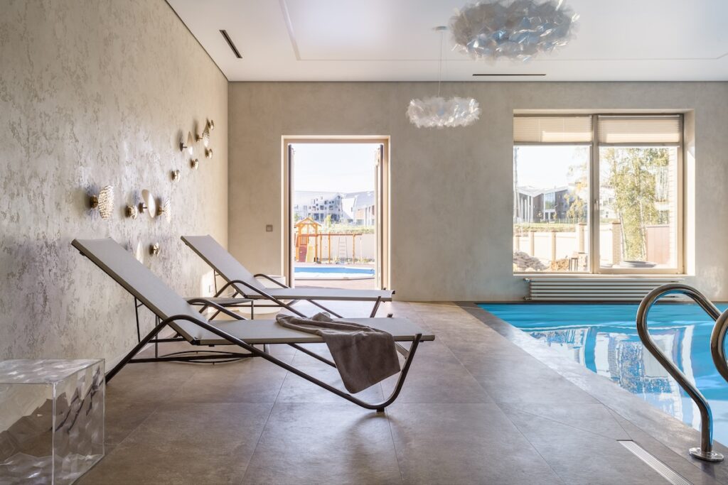 indoor pool with chaise lounges