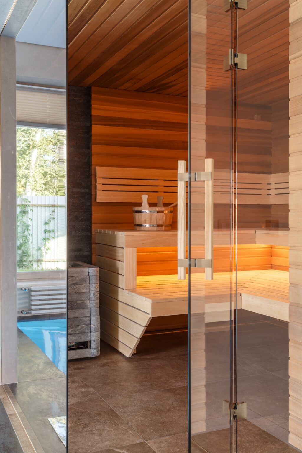 indoor sauna with wooden seating and warm lighting