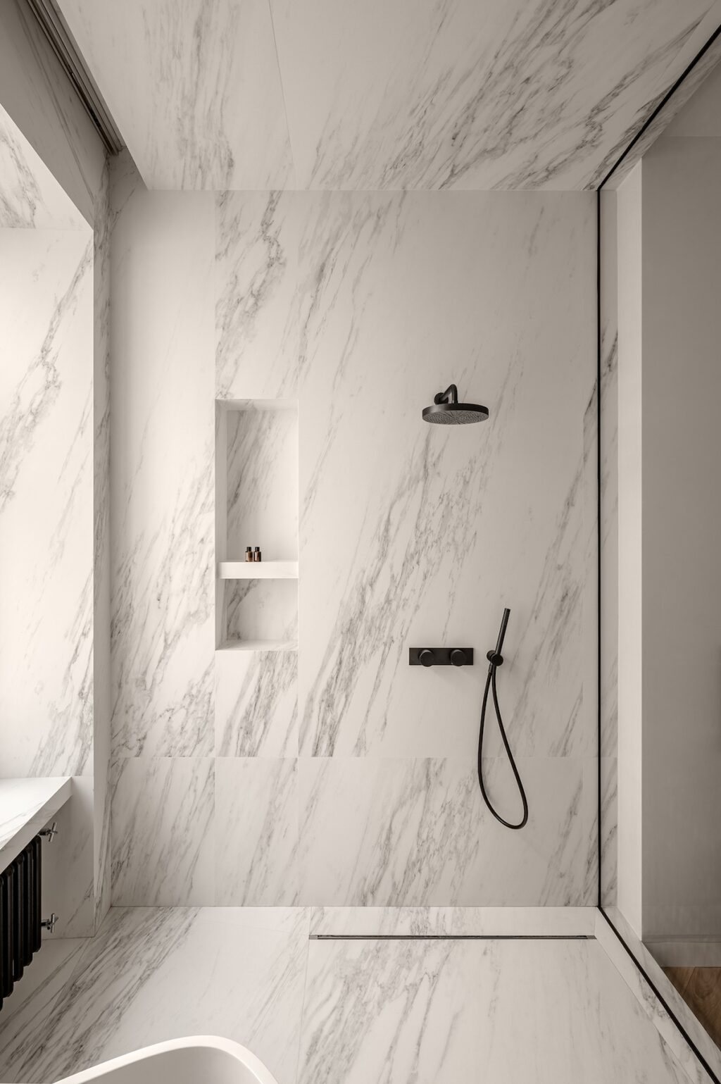 sleek shower area with marble tiles