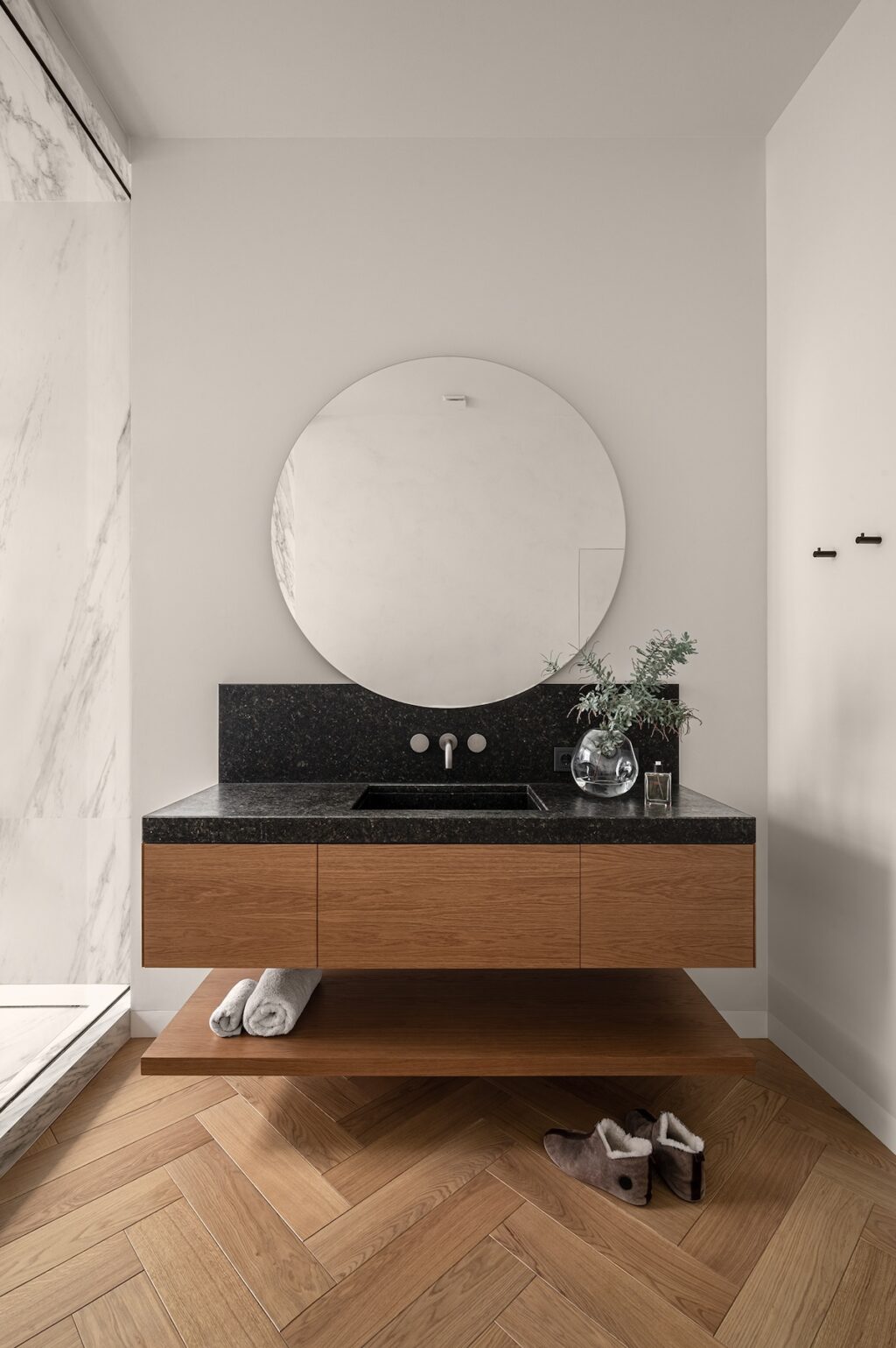 wall mounted wood and marble vanity with round mirror