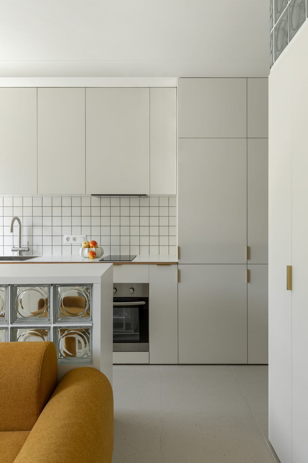 sleek white kitchen with gold hardware