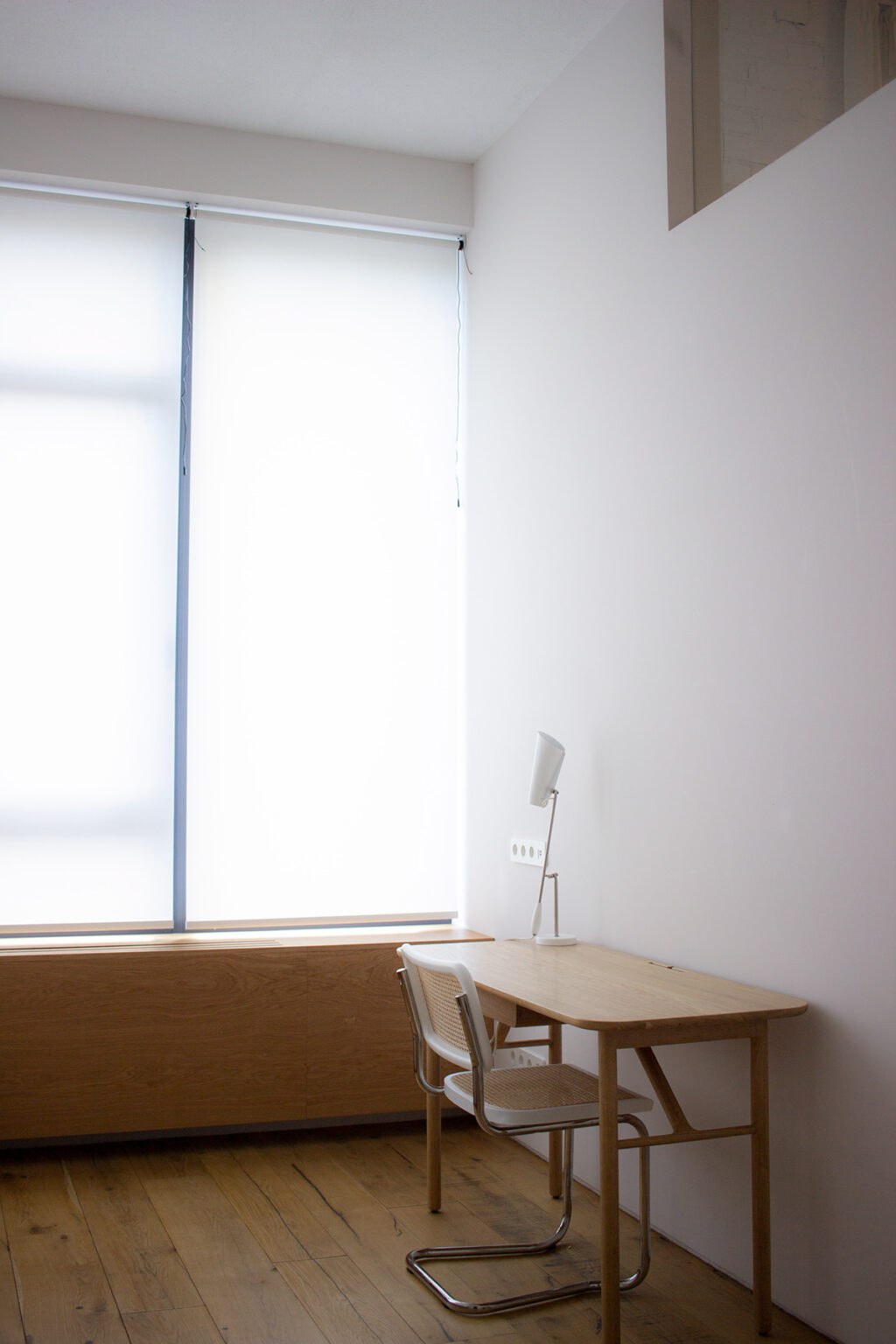 light oakwood desk and rattan chair